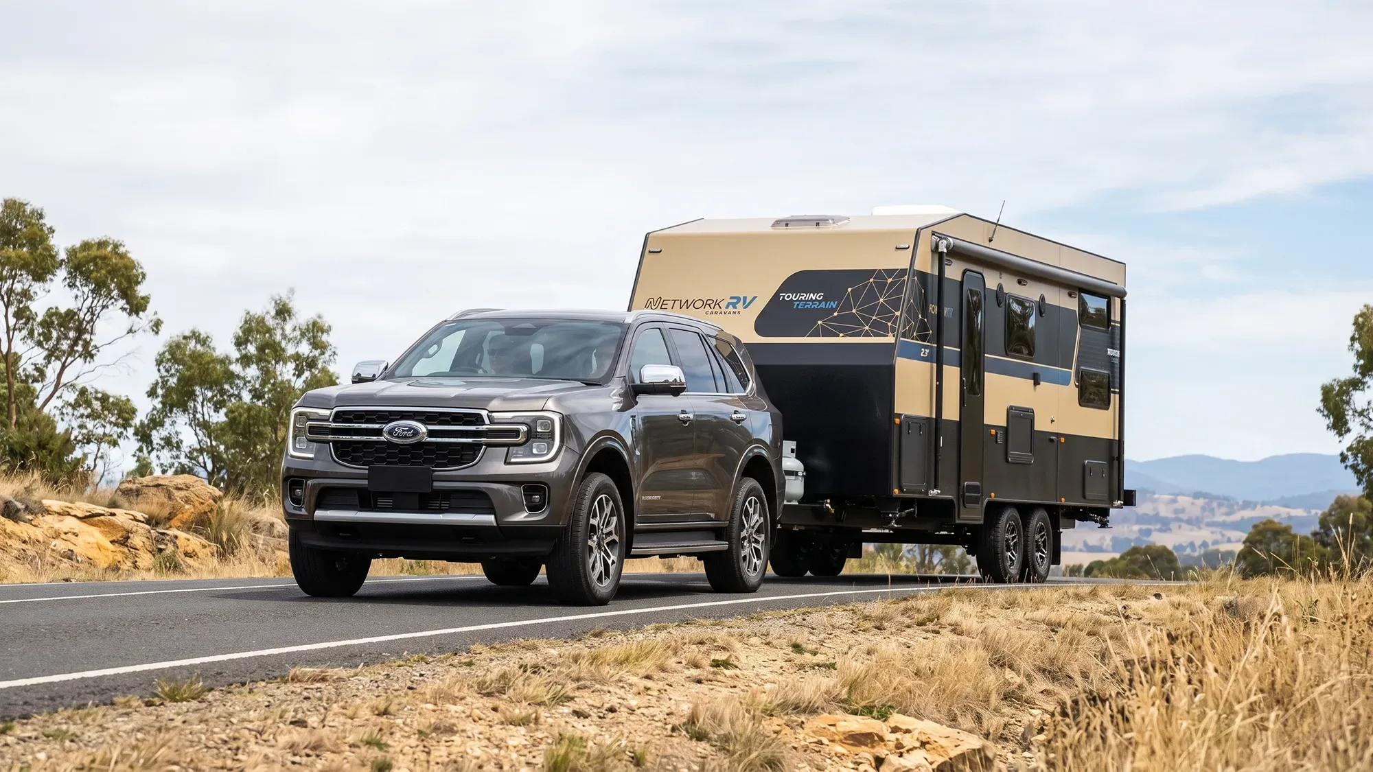 Network RV Touring Terrain touring caravan parked on a sealed coastal road, three-quarter front view